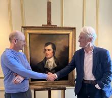 William Zachs and Duncan Thomson with the Raeburn: two men shaking hands in front of an oil painting
