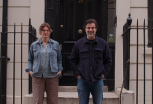 Hester Blum and Rob Delaney stand in front of a Georgian townhouse