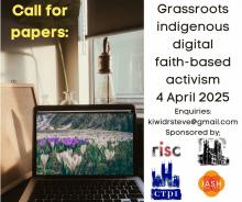 Call for Papers: a field of flowers on a laptop screen with a lamp behind