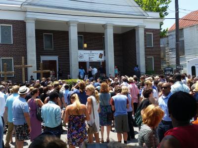 The image shows the crowd outside the Charleston church shooting memorial service in 2015. As the ch