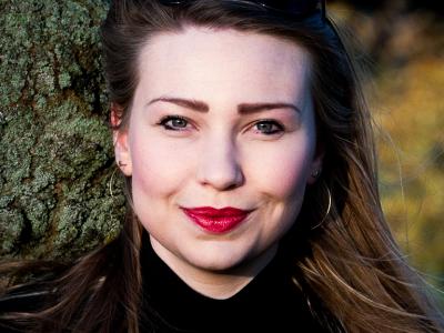 Isla Cowan - a young white woman with long hair, smiling at the camera