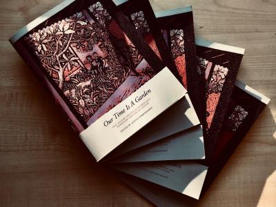 Our Time Is A Garden A number of copies of new book "Our Time Is A Garden" fanned out on a table