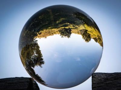 Glass globe reflecting a field behind