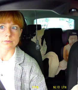 A woman sits in a car with cutout figures in the other seats. Image credit: Shona Macnaughton - Here to Deliver.