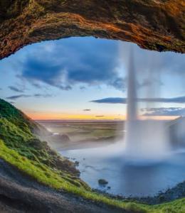 Sunset view from the back of the Seljalandsfoss waterfall, Suðurland, Iceland.