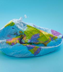 A deflated beach ball with the design of a globe